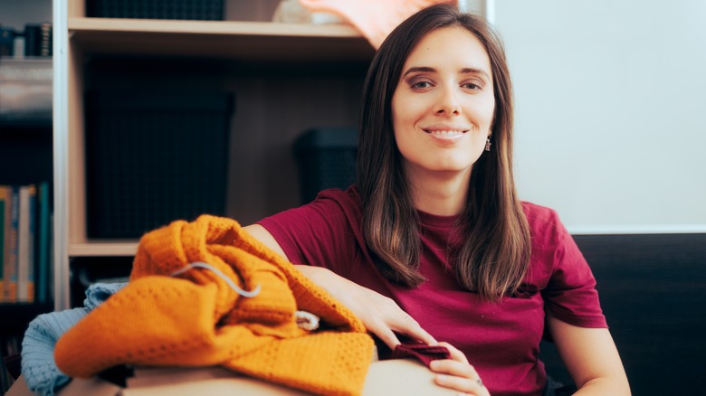 A woman with a box of clothes to donate