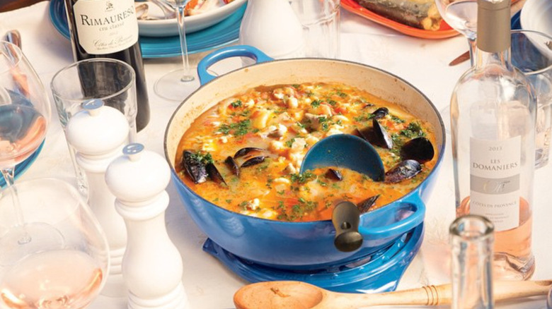 Seafood in a blue Le Creuset pot