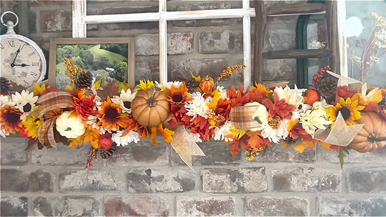 A fireplace mantle decorated for fall using a DIY garland