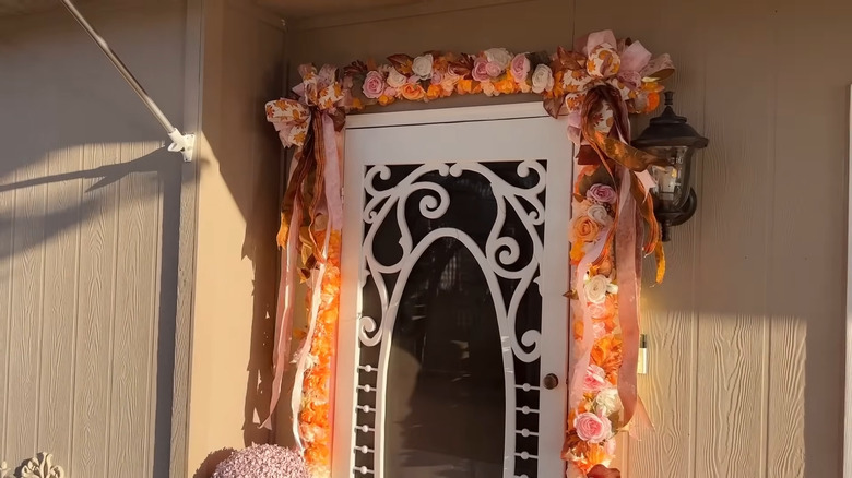 A floral garland around a door frame