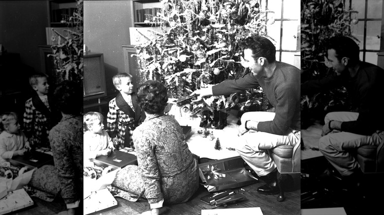 A family open gifts around ther Christmas tree in 1950