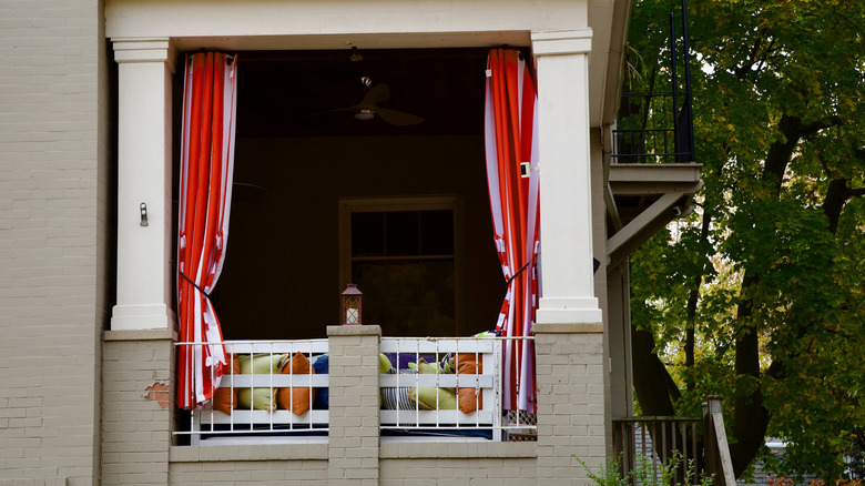 House porch with bright red and purple striped curtains