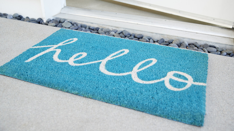 Bright blue doormat that reads "Hello"