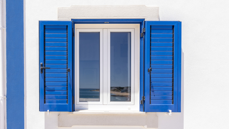 White home exterior with bright blue shutters
