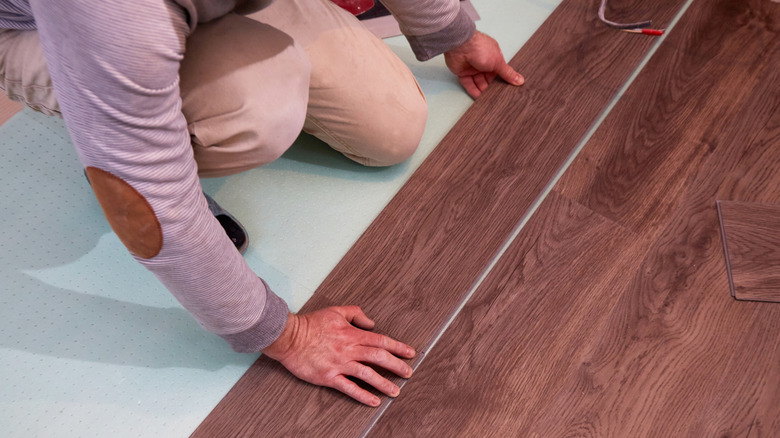 Man putting down a vinyl floor