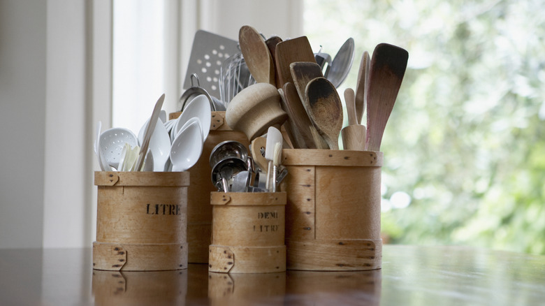 Containers of kitchen tools on a counter