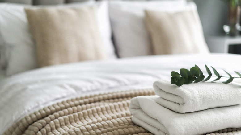 A made bed with extra linens