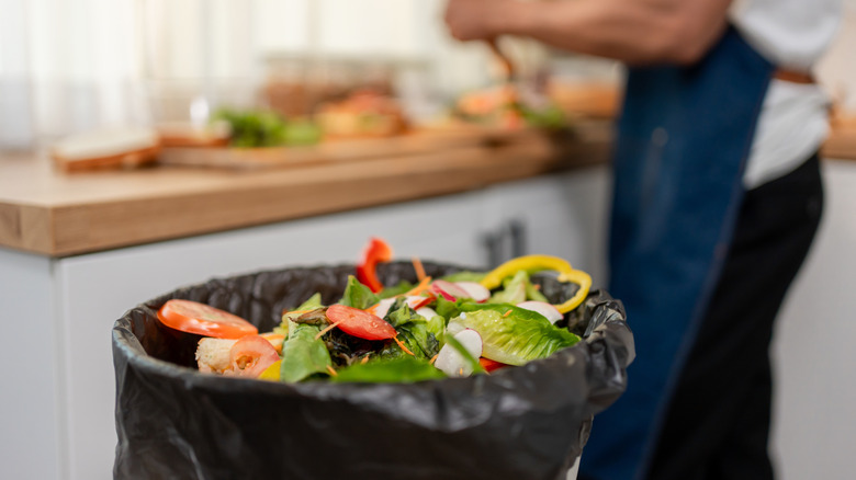 Bin in kitchen filled with food scraps