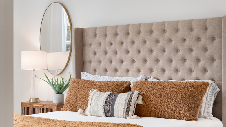 A bed with a large headboard