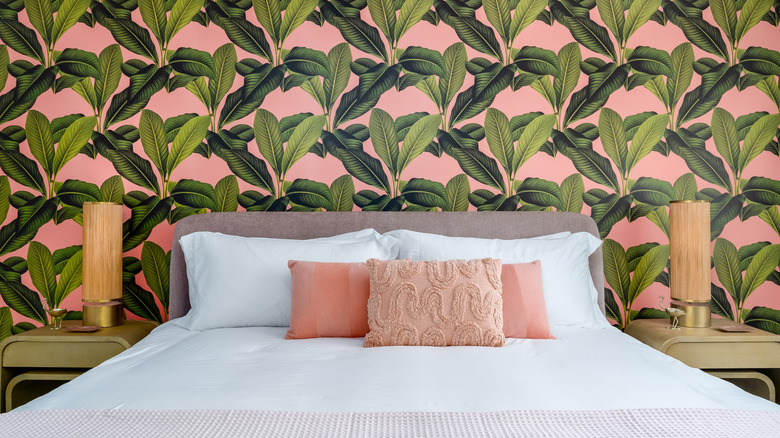 Bed with wallpaper behind it