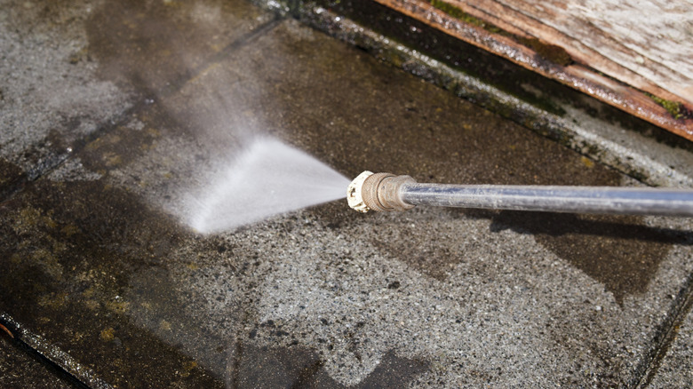 Pressure washing a section of concrete