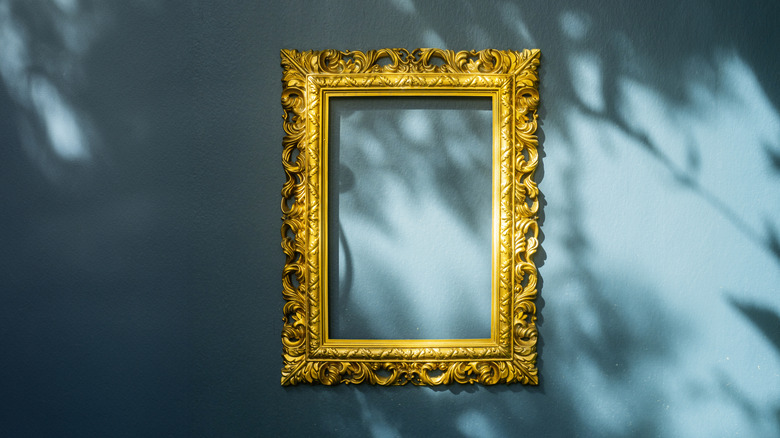 Gilded frame against a blue background with shadows