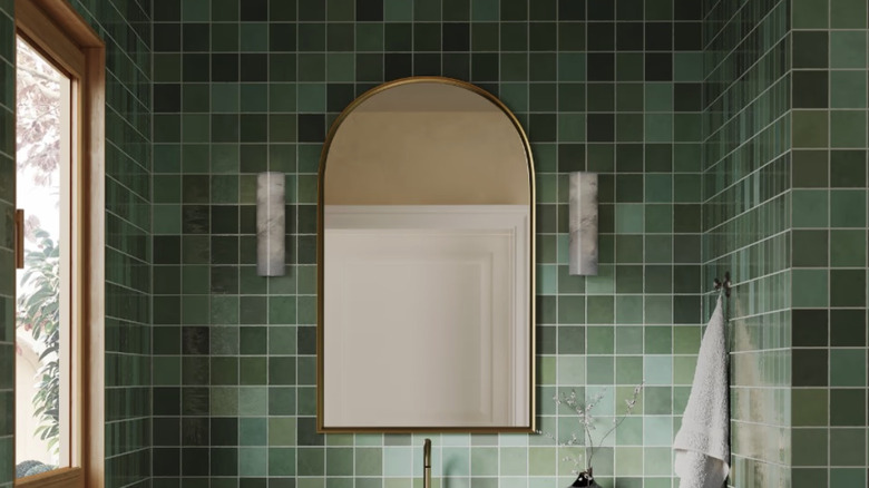 A bathroom vanity with Tilebar's Portmore glossy ceramic tiles in green on the walls