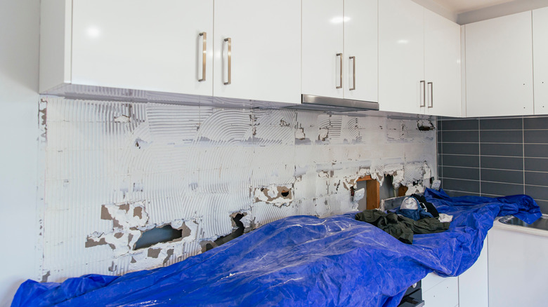 A kitchen backsplash wall prepared for the application of tiles.