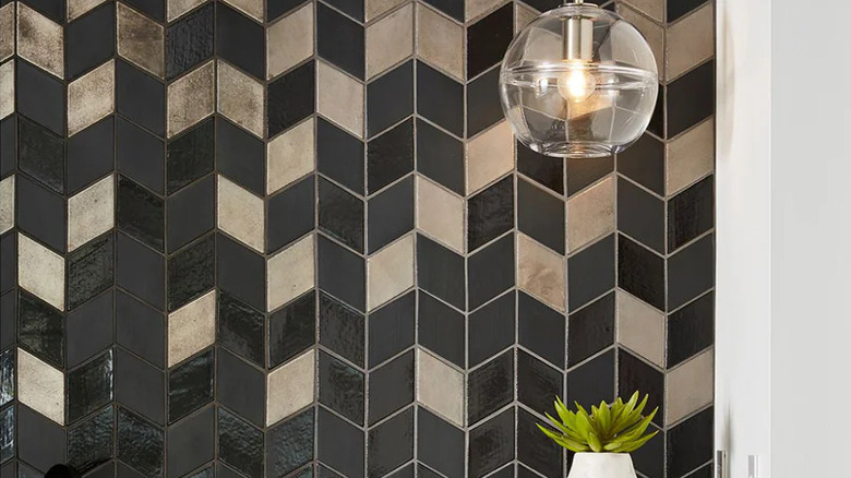 Black and gold tile backsplash with unique, non-repeating pattern