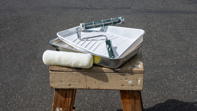 Paint tray with white liner on a wooden stool