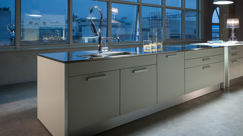 A modern kitchen with concrete flooring
