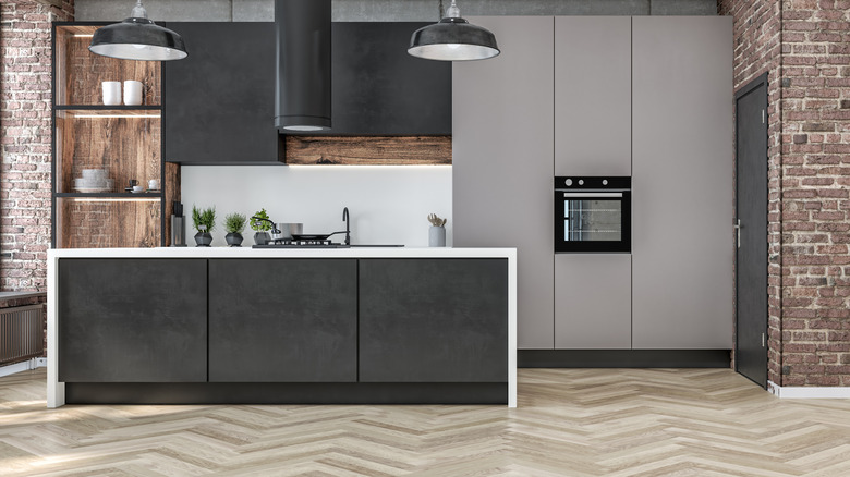 A modern kitchen with herringbone wood flooring