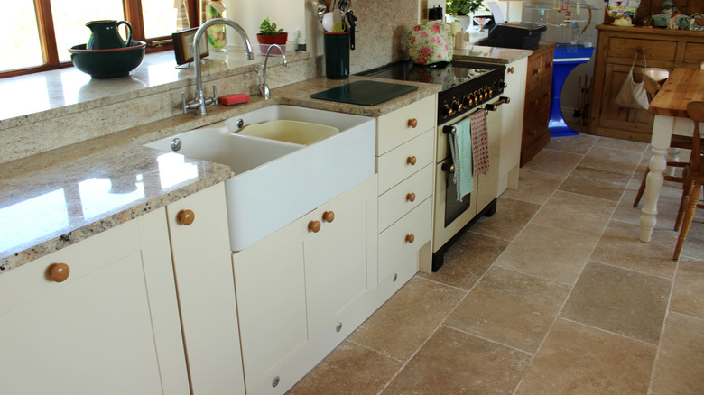 A shaker kitchen laid with stone floor tiles