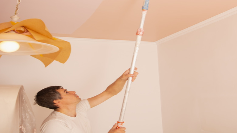 Painting the ceiling light pink with a roller