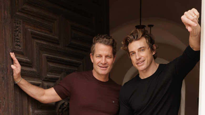 Nate Berkus and Jeremiah Brent smiling in open doorway