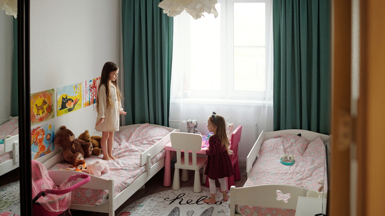 Two girls in symmetrical shared bedroom