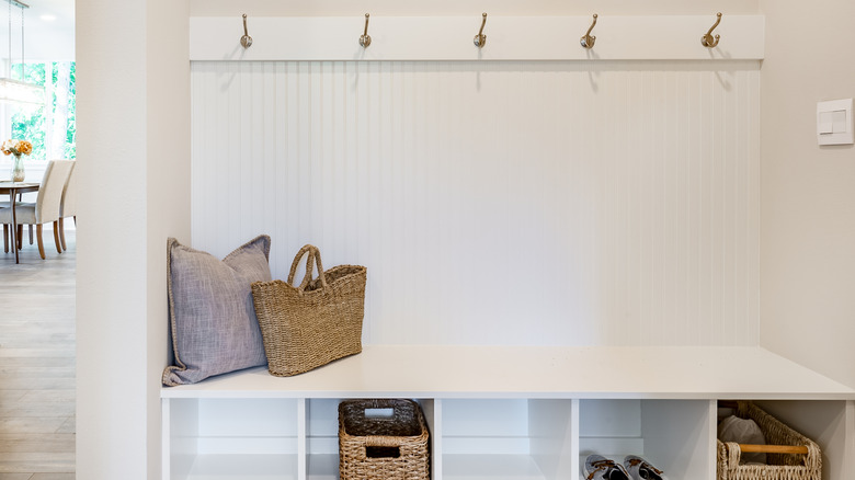well designed hallway with coat hooks and shoe storage
