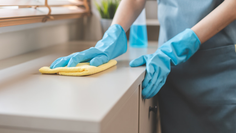 person cleaning furniture