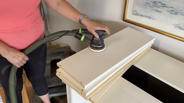 person sanding Ikea furniture