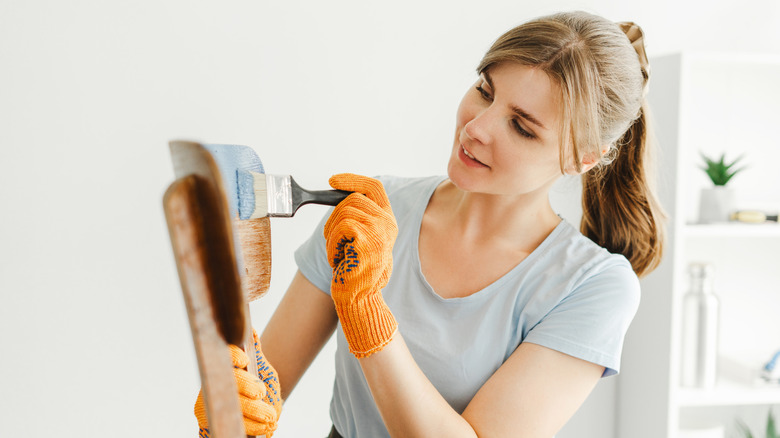 person painting chair