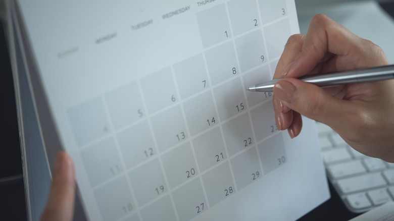 Hand writing on a paper calendar