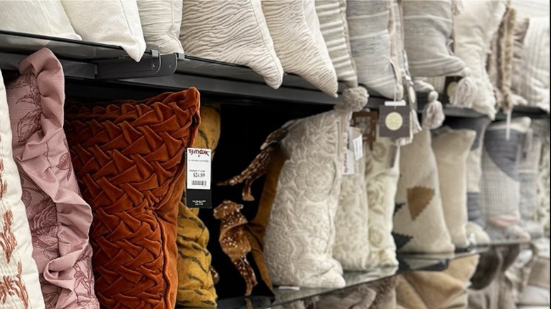 shelves of throw pillows in store