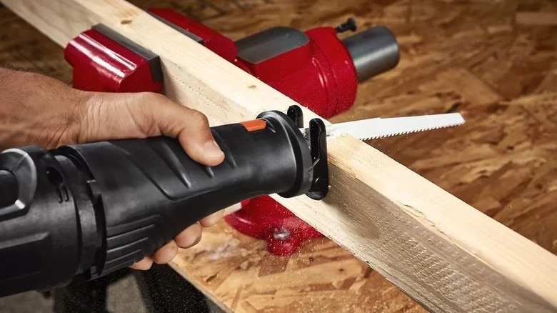 Person using a reciprocating saw on a 2 x 4