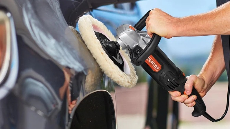Person using a power polisher on a car
