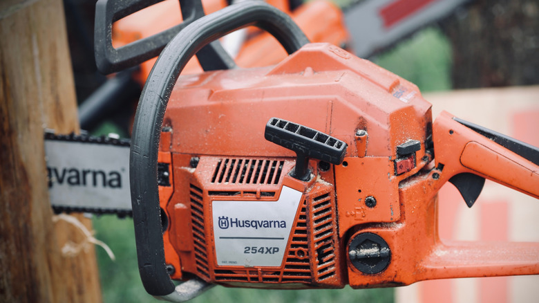 Husqvarna chainsaw sawing through wood