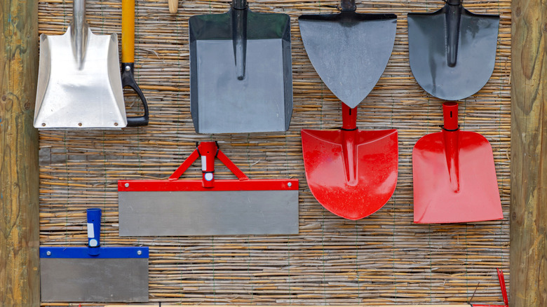different heads of gardening tools in a wicker tray