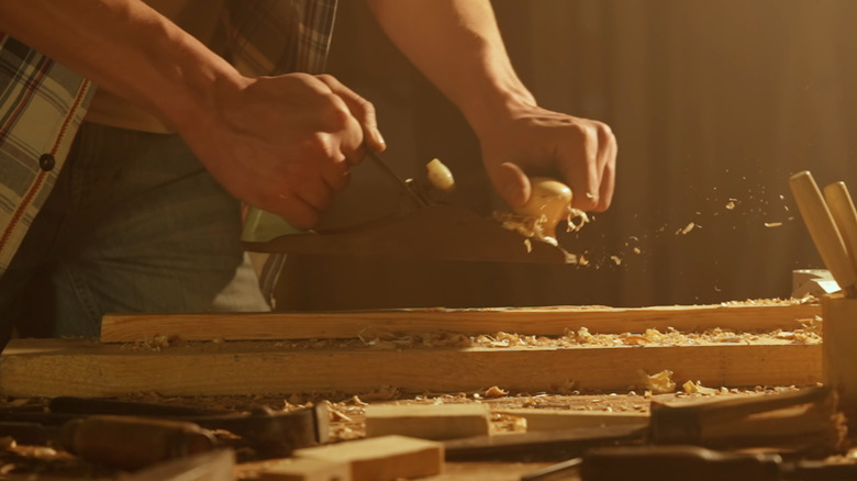 carpenter using hand plane