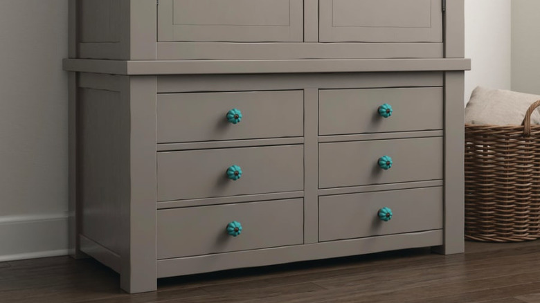 A close-up of drawers with blue ceramic knobs.