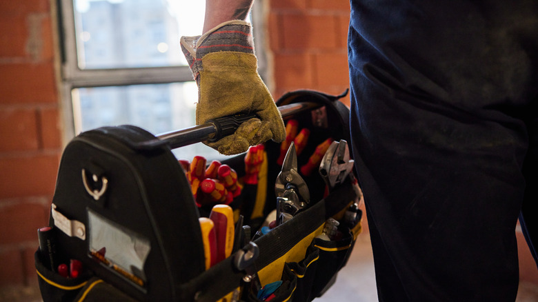 person carrying tool box