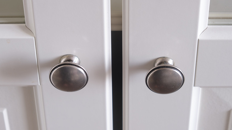 Round silver knobs on cabinet doors