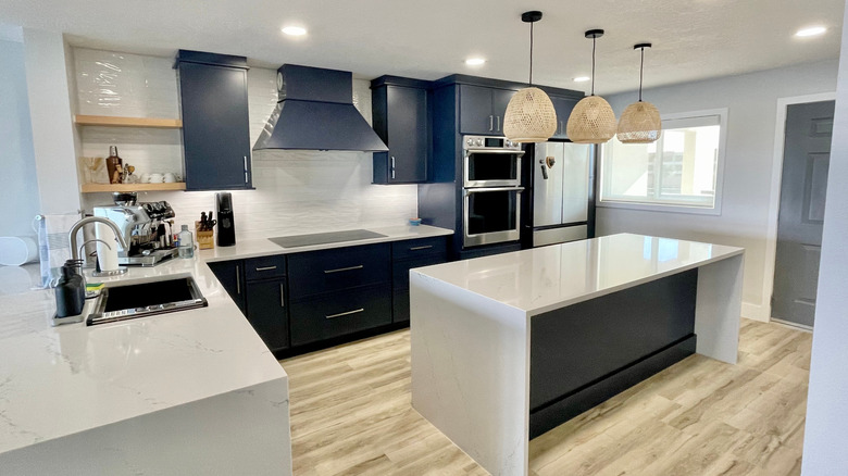 Navy blue cabinets with white marble counters.