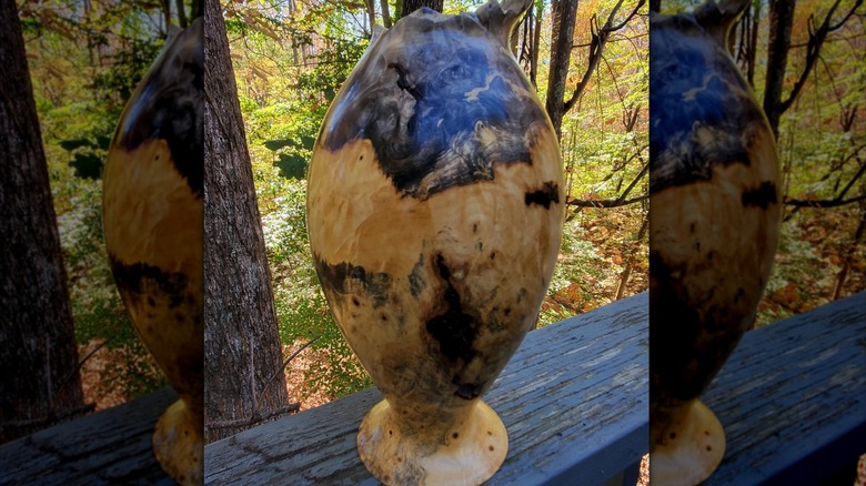 Buckeye burl vase outside on a ledge