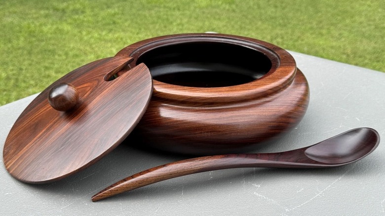 A cocobolo burl serving bowl with a spoon