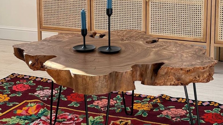 An exquisitely crafted elm burl coffee table with candlesticks on top