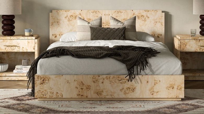 A mappa burl bed frame  and side tables in a decorated bedroom