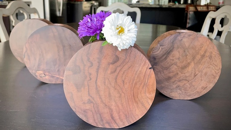 Walnut burl circular vases on a table