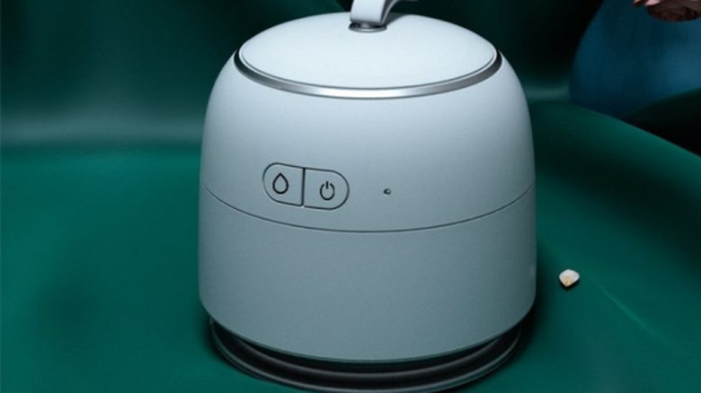 iroon ultrasonic iron on a piece of clothing with a soft focus background