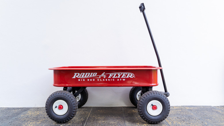 Red wagon on a dark tile floor