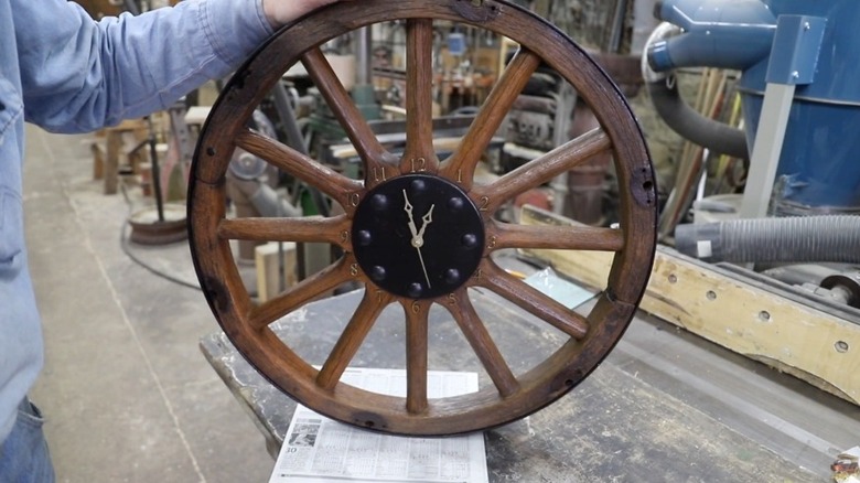 A wooden clock made from old wagon wheel