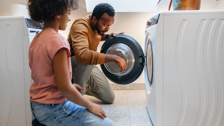 Man looking into washing machine